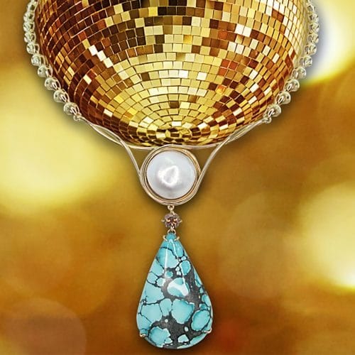 Fashioned yellow gold necklace. In the center a Mabé pearl with a veined turquoise pear-shaped cabochon. Yellow fancy diamond.